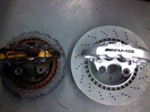 A destroyed brake caused by ignoring the temporary spare tire usage guidelines.
