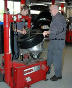 Dobbs Tire & Auto Centers Certified Technicians Rimming a Tire