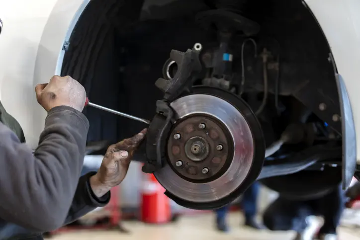 Certified Technician working on vehicles brakes