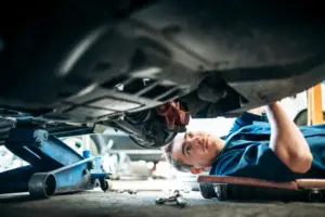 Certified Technician working under vehicle