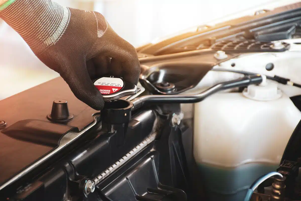 mechanic checking radiator cap