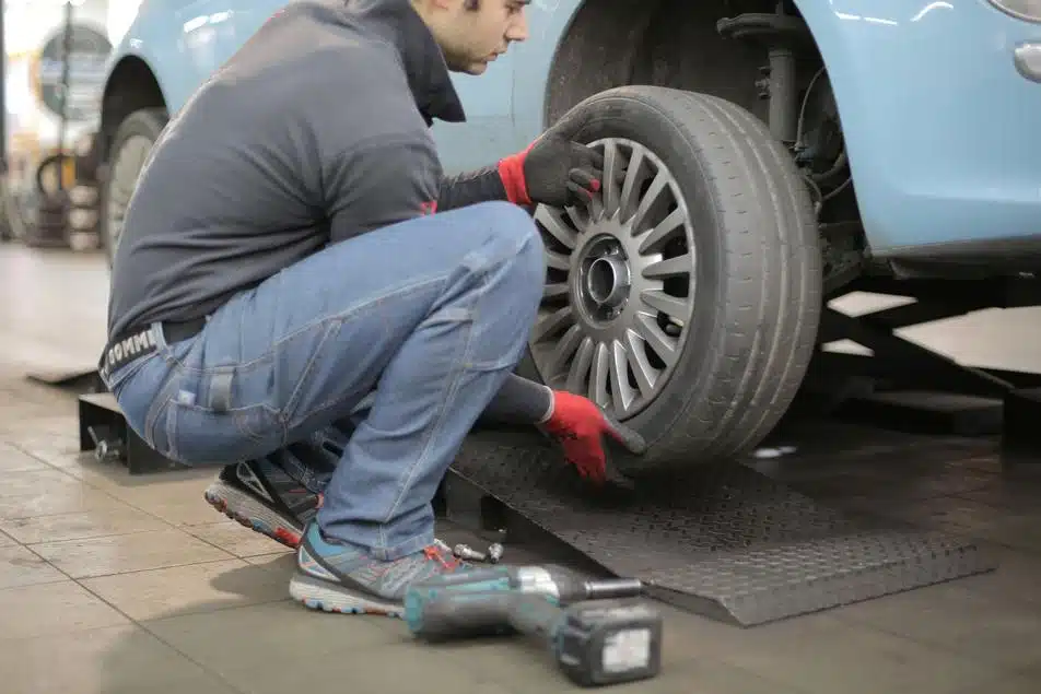man changing flat tire