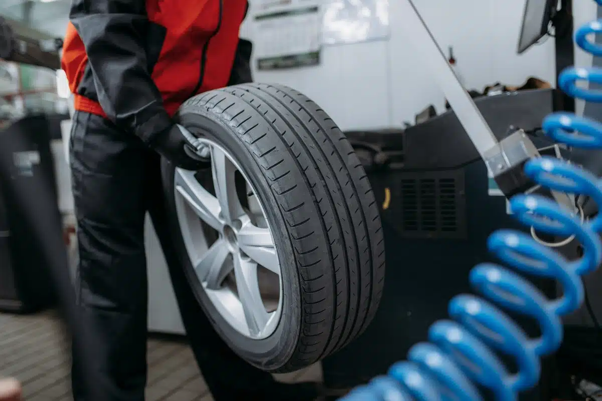 mechanic performing tire balancing services