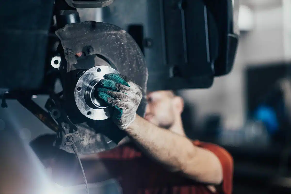mechanic repairing wheel bearing