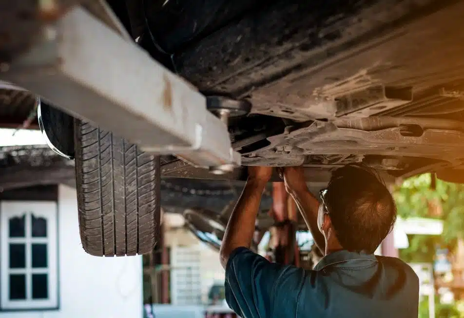mechanic performing suspension system maintenance