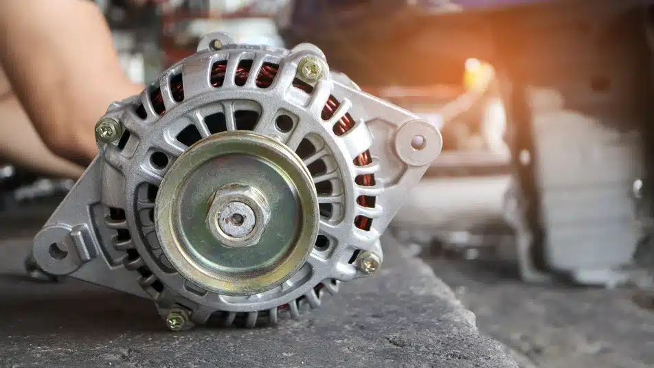 car mechanic replacing alternator in vehicle