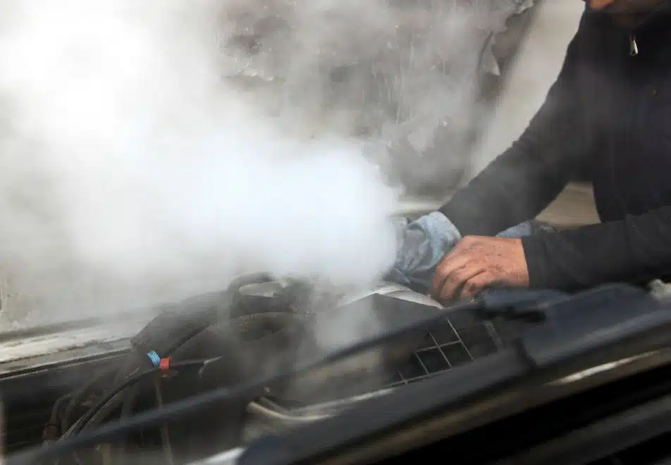 mechanic repairing overheating car engine