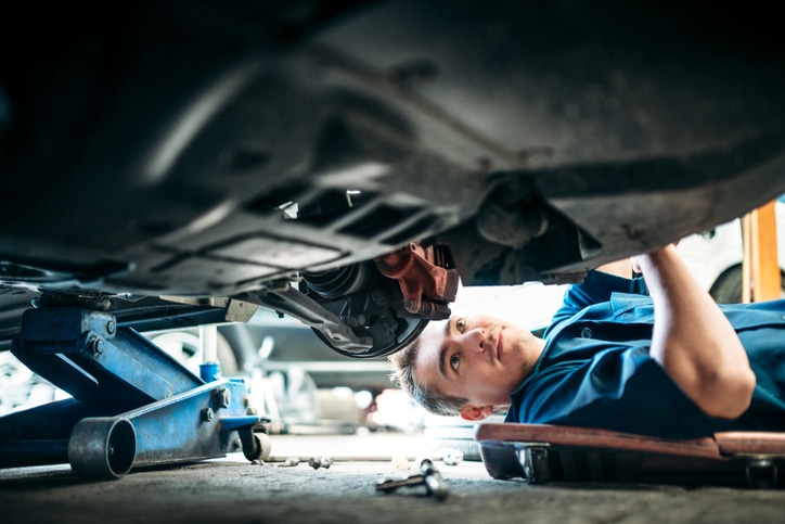 Certified Technician working under vehicle