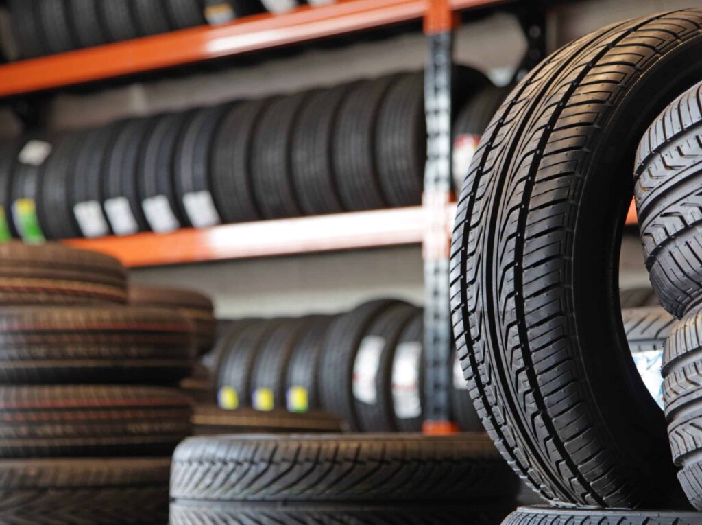 new auto tires shown stocked and shelved in a tire warehouse showroom